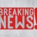 Breaking news icon on grey textured background