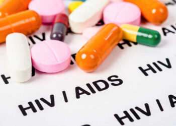 Pills on Hiv / aids paper background.