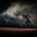 Young male athlete running on race track.