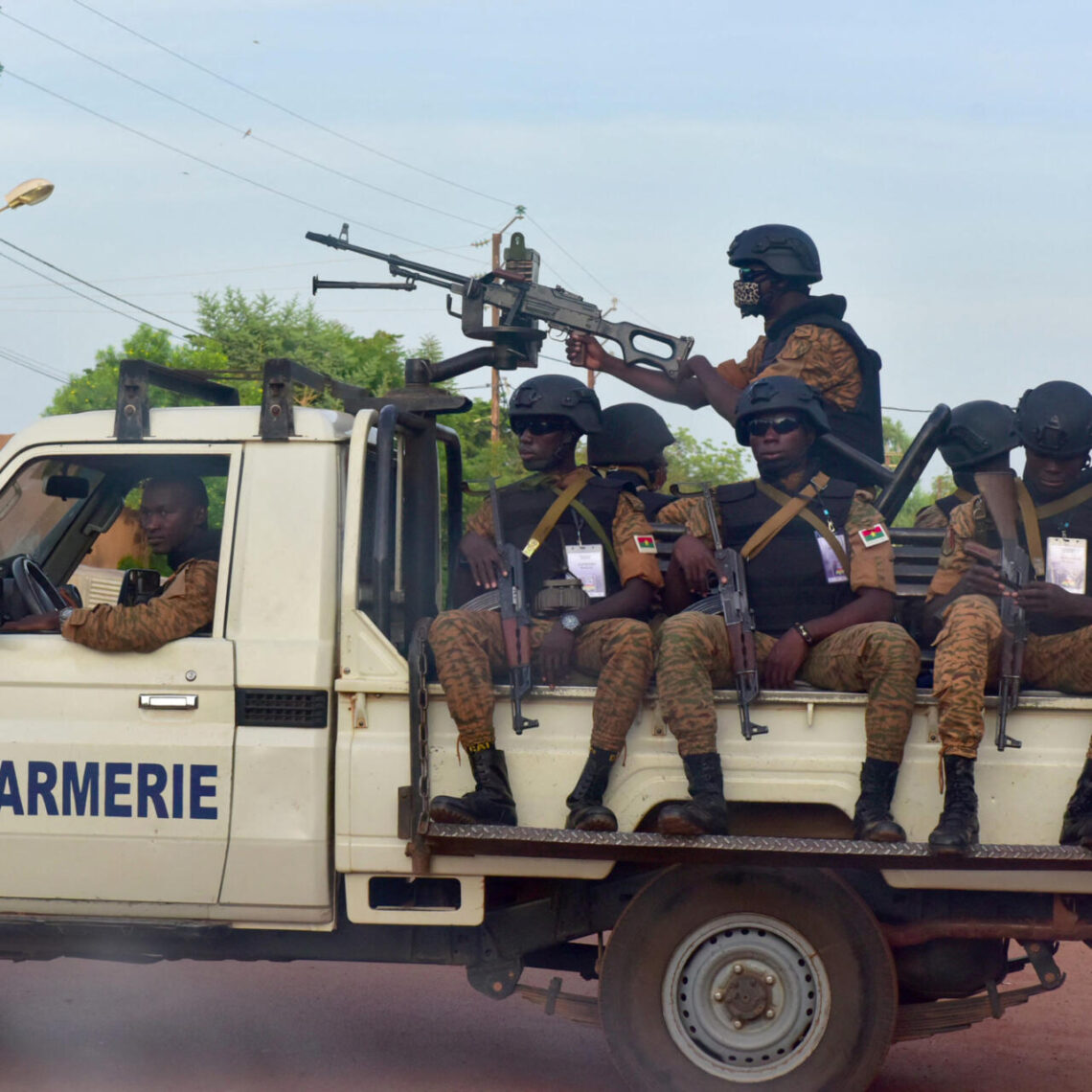A picture take on October 30, 2018 shows Burkinabe gendarmes sitting on their vehicle in the city of Ouhigouya in the north of the country. - Two Burkinabe soldiers were killed and three wounded in the night of November 5, 2018 in Nassoumbou, northern Burkina Faso, near the Malian border, by the explosion of an improvised explosive device, according to security sources. (Photo by ISSOUF SANOGO / AFP)