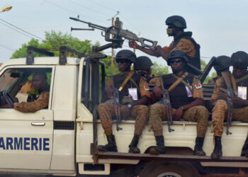 A picture take on October 30, 2018 shows Burkinabe gendarmes sitting on their vehicle in the city of Ouhigouya in the north of the country. - Two Burkinabe soldiers were killed and three wounded in the night of November 5, 2018 in Nassoumbou, northern Burkina Faso, near the Malian border, by the explosion of an improvised explosive device, according to security sources. (Photo by ISSOUF SANOGO / AFP)