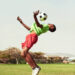 Shot of a young boy playing soccer on a sports field